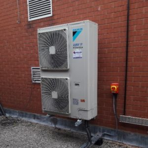 Air conditioning unit outside brick building