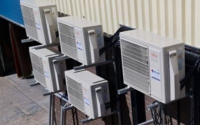 Air conditioning outside corrugated metal sheet building
