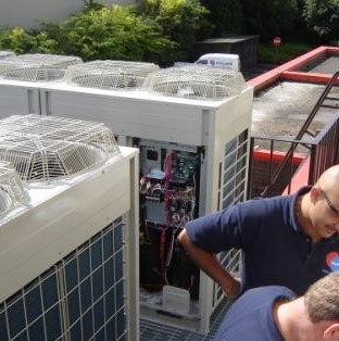 Workers operating outside on air conditioning