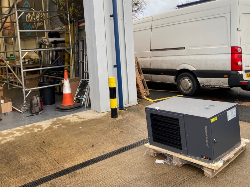 Powrmatic air conditioning ventilation unit outside building on wooden pallet