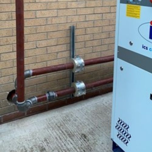Climatic Chamber & ICS Chiller metal pipe on brick wall