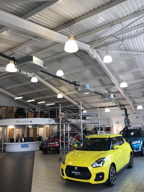 Ceiling air conditioning units in a car showroom