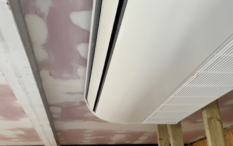 Air conditioning unit on pink unpainted roof