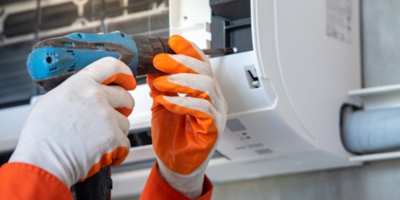 Engineer fixing an air conditioner