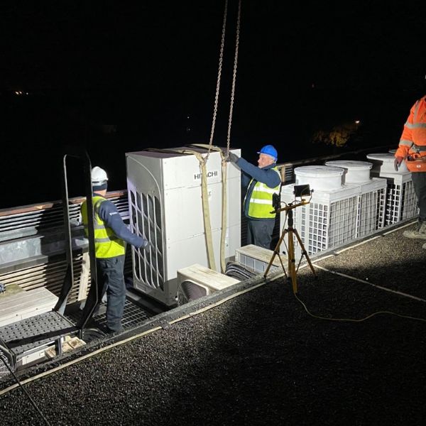 Chillaire installing Hitachi air conditioning unit on a roof