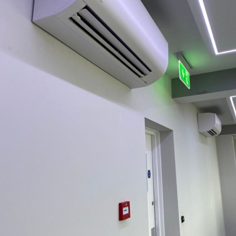Air conditioning units on wall next to fire exit
