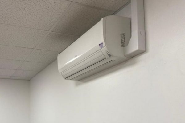 Simple air conditioning unit on white wall