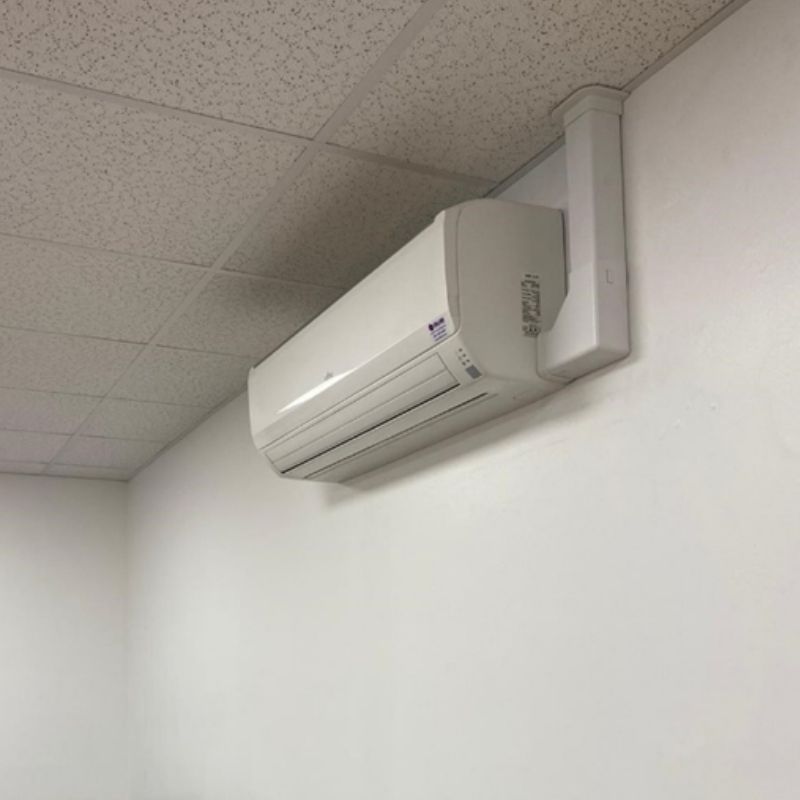 Simple air conditioning unit on white wall